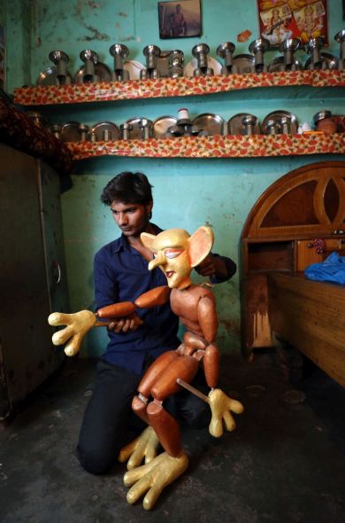 Puppeteer Sarju Bhaat practises using his puppets at his home in the Kathputli slum colony of New Delhi, India, December 7th, 2014. He is one of 40,000 people living in the slum, which is popularly known for being the worlds largest colony of street performers, including magicians, snake charmers, acrobats, singers, dancers, actors, traditional healers and musicians and puppeteers. Their livelihood is under threat however as the Delhi government has obtained contracts to demolish the colony to make way for developers to build high-rise apartments. Photo Credit: Susannah Ireland