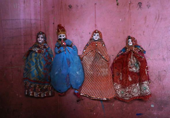 Rajasthani puppets are pictured in the home of a puppet maker Ghita Devi in the Kathputli slum colony of New Delhi, India, December 8th, 2014. Ghita is one of 40,000 people living in the slum, which is popularly known for being the worlds largest colony of street performers, including magicians, snake charmers, acrobats, singers, dancers, actors, traditional healers and musicians and puppeteers. Their livelihood is under threat however as the Delhi government has obtained contracts to demolish the colony to make way for developers to build high-rise apartments. Photo Credit: Susannah Ireland