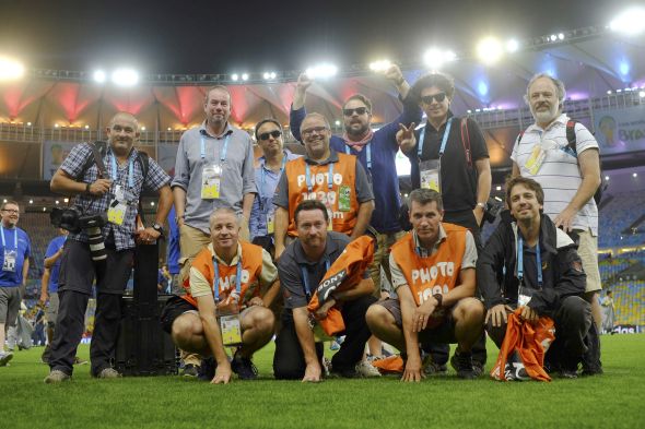 The Reuters photographers after photographing the 2014 World Cup Final, pose for a picture at the Maracana stadium in Rio de Janeiro July 13, 2014. (Top L-R) Michael Dalder, Leonhard Foeger, Dylan Martinez, Sergio Moraes, Kai Pfaffenbach, Damir Sagolj and Paulo Whitaker. (Bottom L-R) Darren Staples, David Gray, Eddie Keogh and Ricardo Moraes. In a project titled ?On The Sidelines?, Reuters award-winning photographers are sharing pictures showing their own quirky and creative view of the 2014 World Cup in Brazil. Their images offer an insight behind the scenes of the tournament, revealing the photographers? experiences as they live in and travel around Brazil. REUTERS/Paul Robinson (BRAZIL - Tags: MEDIA SOCIETY SPORT SOCCER WORLD CUP) - RTR3YWJL