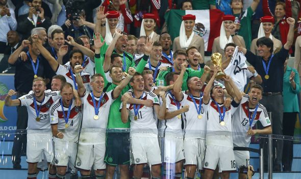 Germany's captain Lahm lifts near coach Loew the World Cup trophy after the 2014 World Cup final against Argentina at the Maracana stadium in Rio de Janeiro