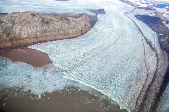 A glacier melting into Kongsfjorden bay outside Ny-Ålesund, Svalbard.