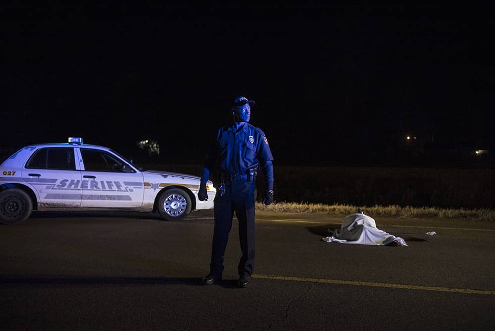 29/11/2014 Tchula Mississippi USA. Patrolman Willie Phillips Jnr born in the town back 7 years at the scene of a shooting where the young man died. Photo Sean Smith